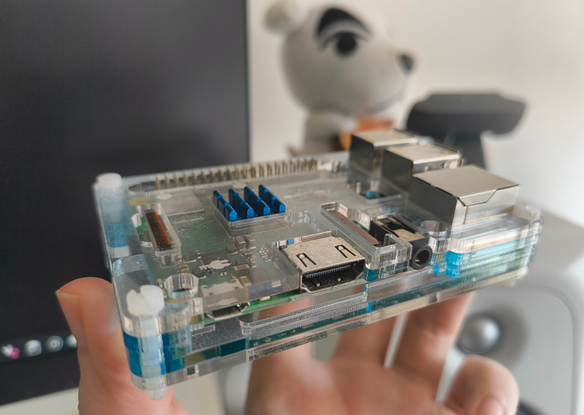 my hand holding up a raspberry pi 3b+